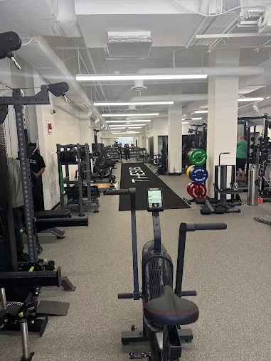 Exercise bikes, weight racks and fitness equipment in a commercial workspace