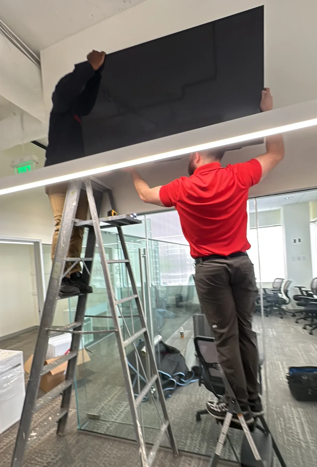 Gorilla Haulers crew handling a large television in an office